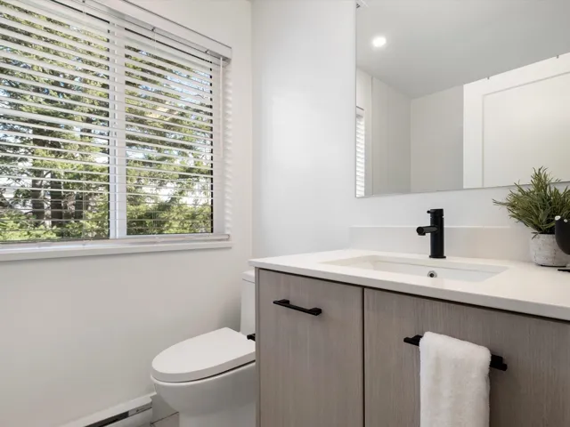 Bathroom featuring recessed lighting, toilet, vanity, and a baseboard radiator