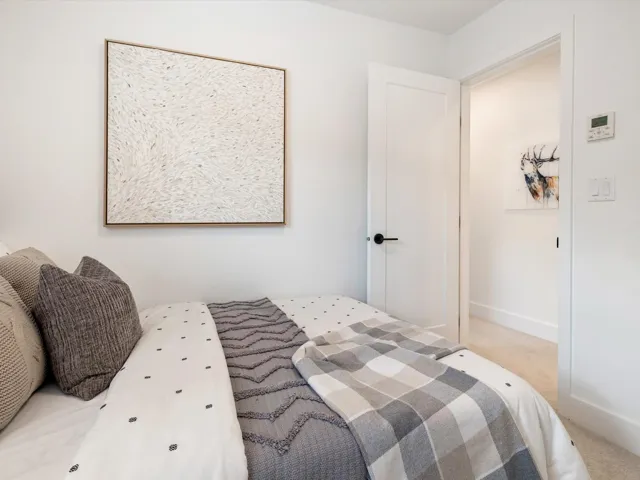 Carpeted bedroom featuring baseboards
