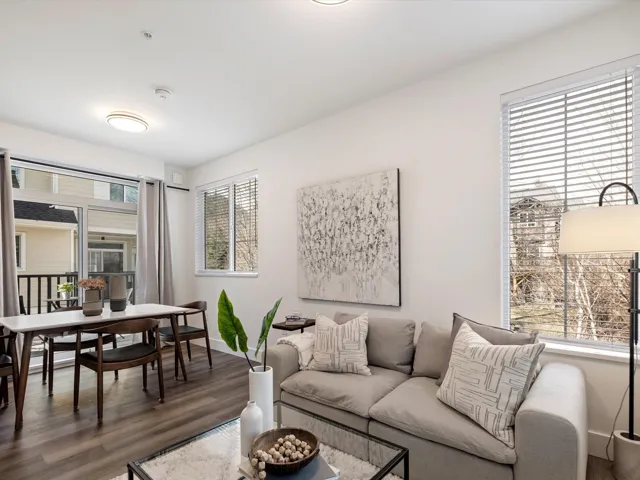 Living room with plenty of natural light, wood finished floors, and baseboards