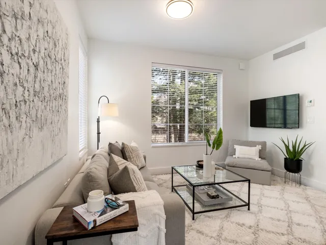 Living room featuring visible vents and baseboards