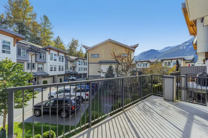 Private balcony with durable decking and a dark metal railing