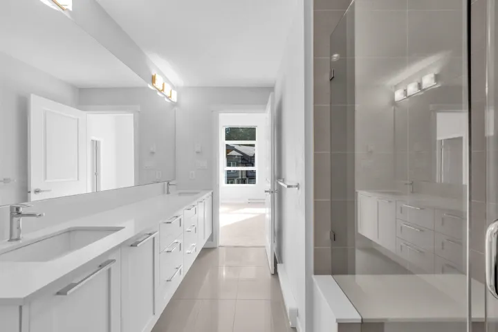 Expansive open-concept living area featuring wood-finish flooring, multiple windows, and recessed lighting
