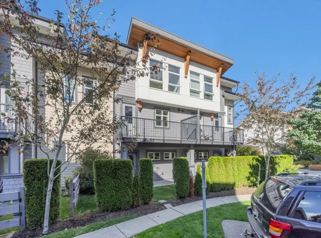 Multiple large windows, neutral carpeting, and white interior doors