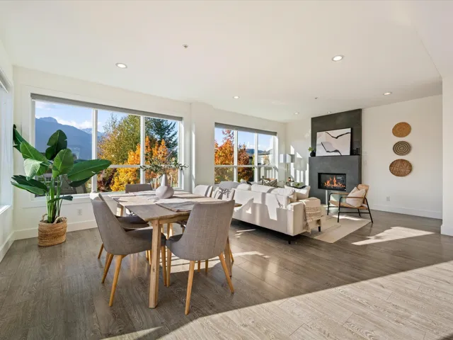Dining space featuring recessed lighting, a large fireplace, and wood finished floors