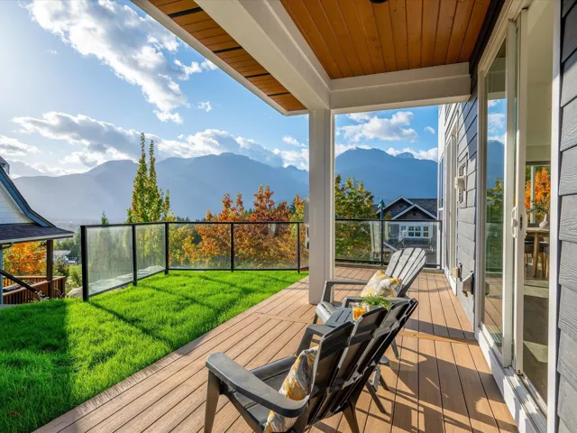 Deck with a yard and a mountain view