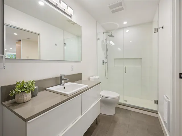 Bathroom featuring vanity, a shower stall, recessed lighting, and dark tile patterned floors