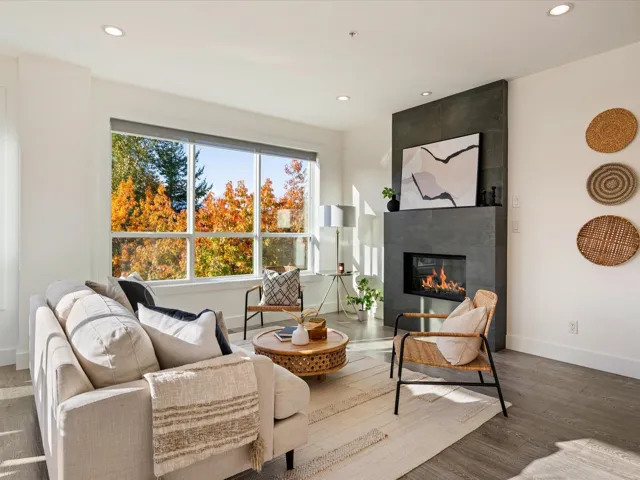 Living area featuring recessed lighting, a tiled fireplace, and wood finished floors