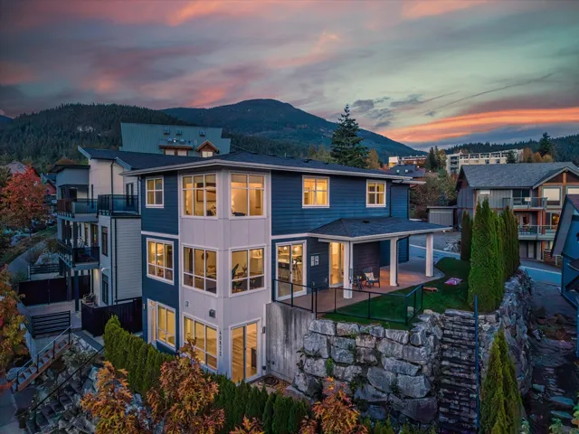 Back of property at dusk featuring a mountain view