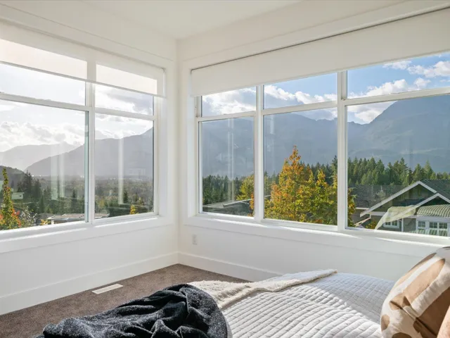 Carpeted bedroom with a mountain view