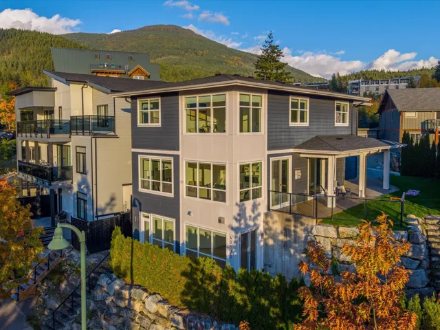 Back of property with a patio, a mountain view, and a balcony
