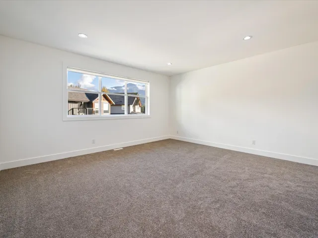 Spare room featuring recessed lighting and dark colored carpet