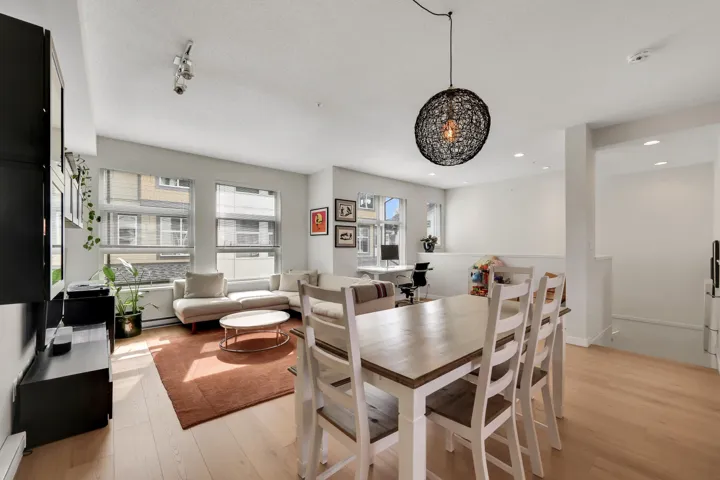 Dining space with light wood finished floors and recessed lighting