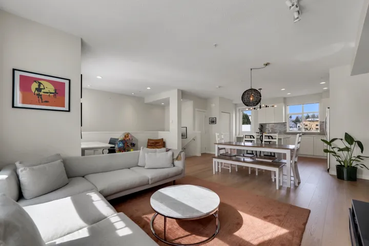 Living room with light wood finished floors and recessed lighting