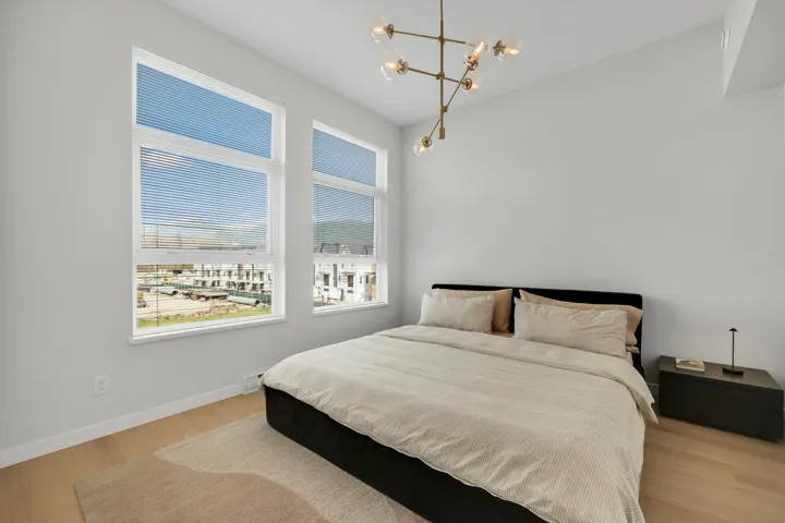 Bedroom with a chandelier and light wood finished floors