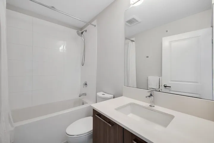 Full bathroom featuring vanity and shower / bathtub combination with curtain