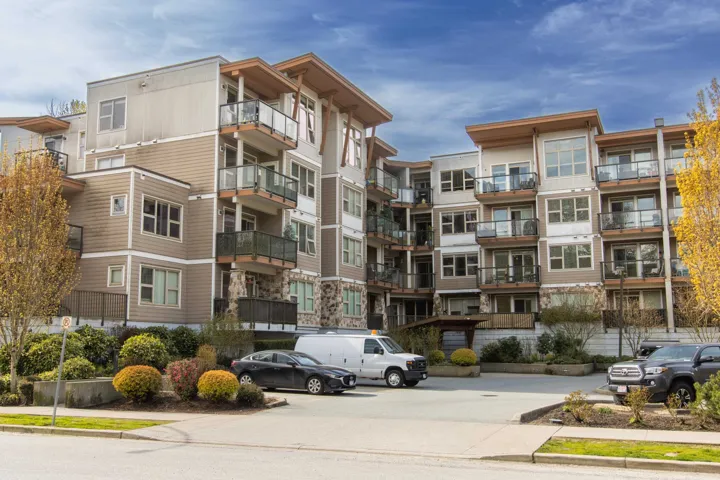 View of property with uncovered parking