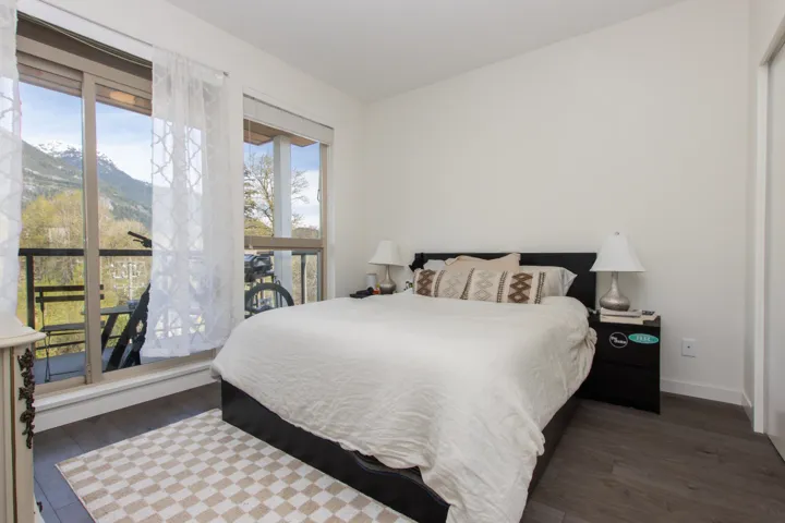 Bedroom with wood finished floors and baseboards