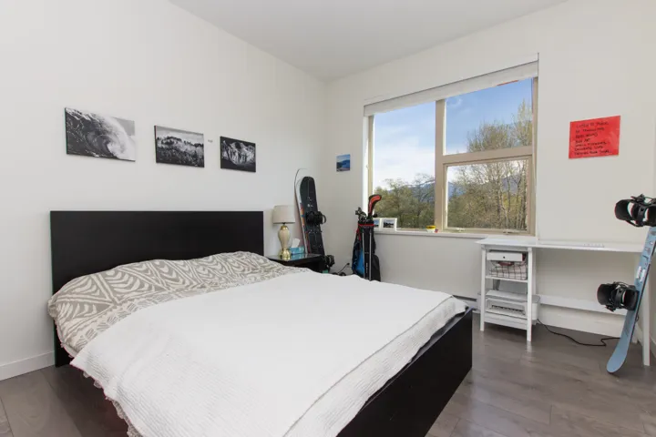 Bedroom with baseboards and dark wood-style flooring