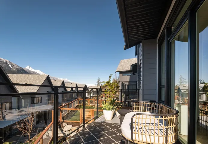 Private balcony featuring a black metal railing and a dark geometric outdoor rug