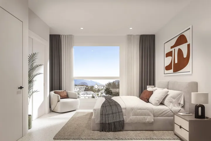 Bright room featuring a wide window with expansive mountain and urban scenery