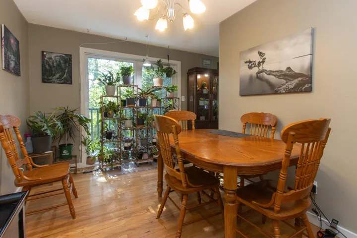Dining space with a notable chandelier and light wood-type flooring