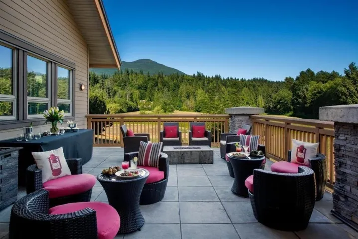 View of patio / terrace with a fire pit, a mountain view, and a view of trees