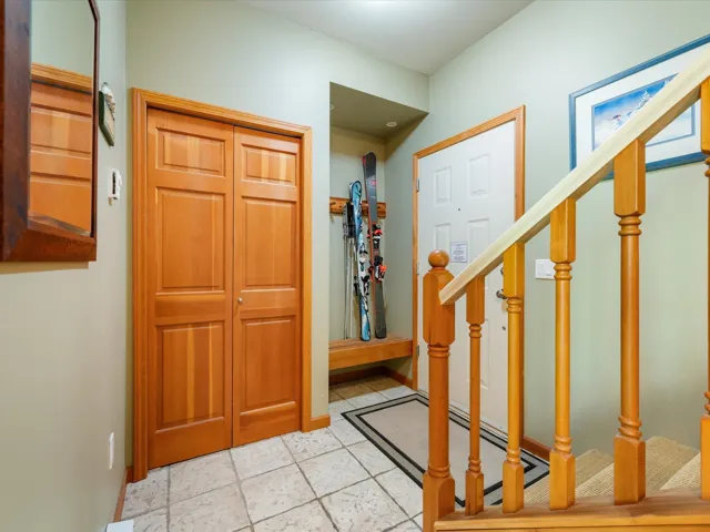 Foyer entrance featuring stairway and light tile patterned floors