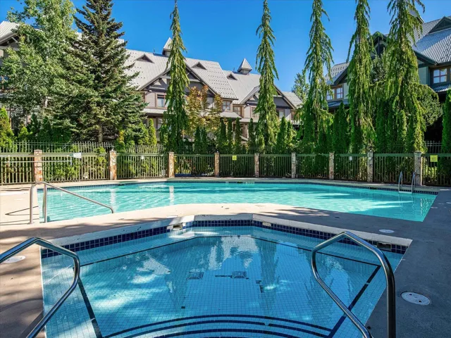Community pool featuring a hot tub