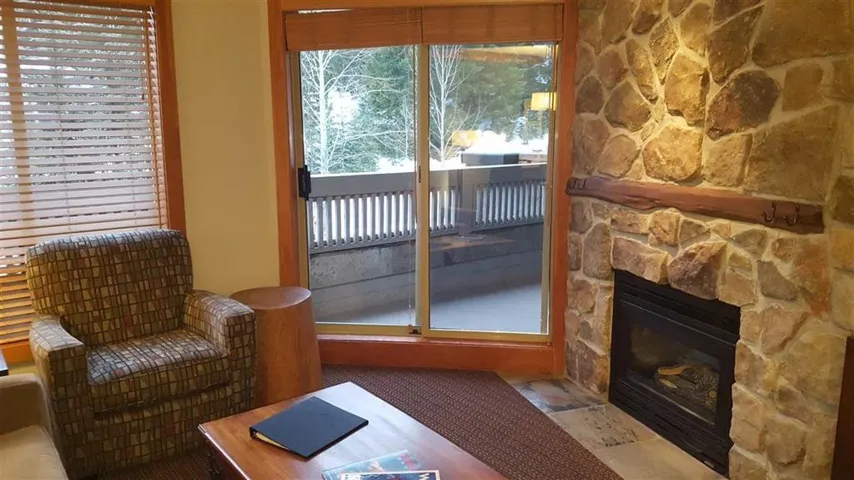 Sitting room with a stone fireplace