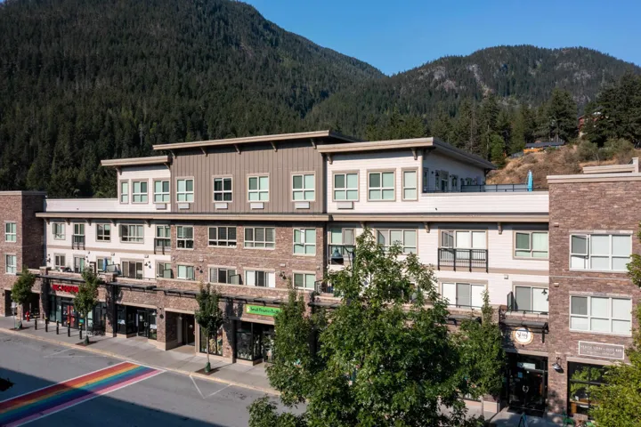 View of building exterior featuring a mountain view and a forest view