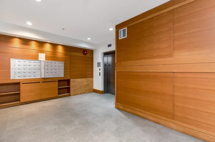 Building lobby featuring recessed lighting and wooden walls