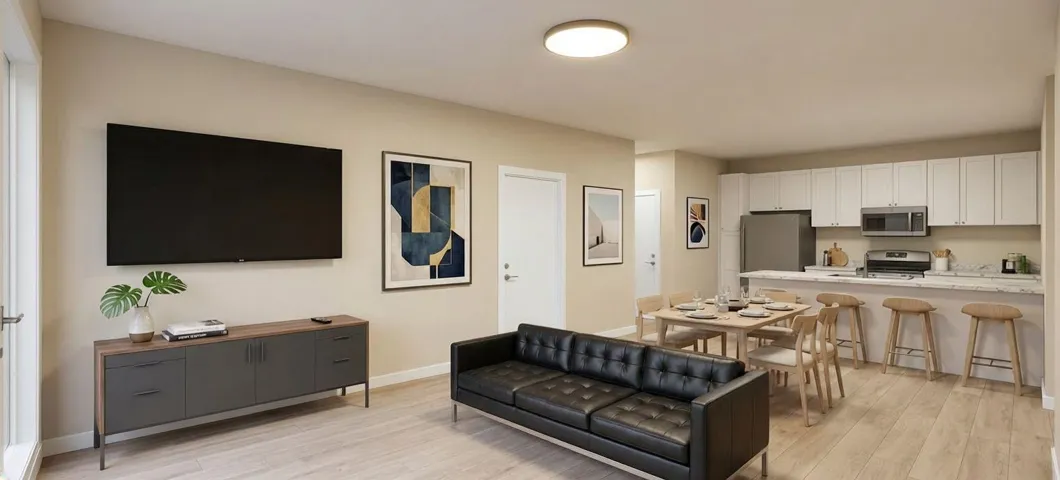 Open-concept living space featuring wood-finish flooring, recessed lighting, white perimeter cabinetry, and stainless steel appliances
