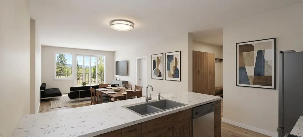 Open-concept kitchen featuring a double basin stainless steel sink, integrated dishwasher, and stone-finish countertops