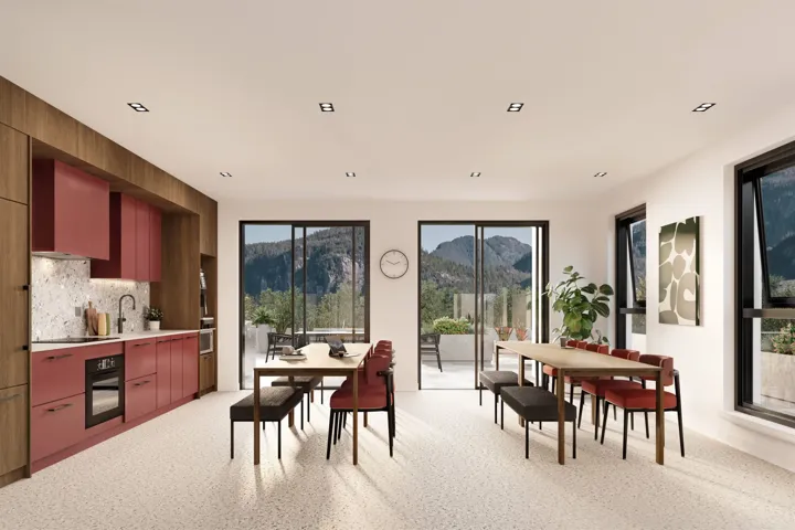 Open-concept room featuring a contemporary kitchen with red cabinetry, integrated appliances, and a light speckled backsplash