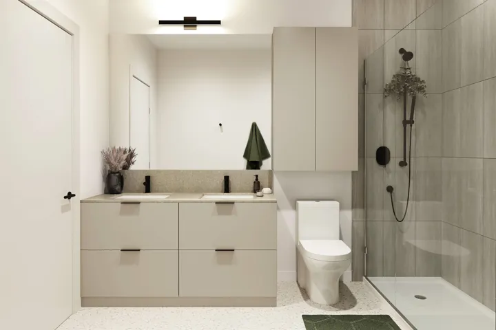 Modern bathroom featuring a dual vanity with light-toned cabinetry and a speckled countertop, a frameless glass shower enclosure with matte black fixtures, an overhead shower head, and a wall-mounted toilet