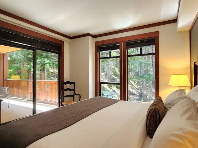 Carpeted bedroom with a baseboard heating unit