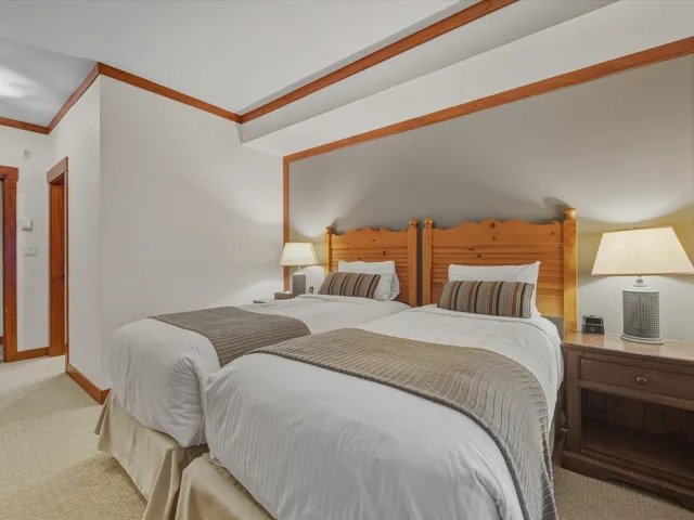 Carpeted bedroom with ornamental molding and baseboards