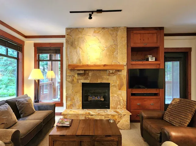 Dining area with carpet flooring, a chandelier, and a baseboard heating unit