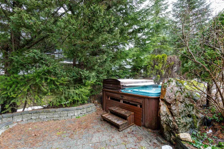 View of front patio / garden with a hot tub