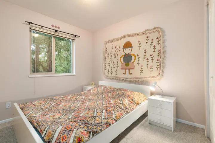 Second Main Floor Bedroom featuring light carpet and baseboards