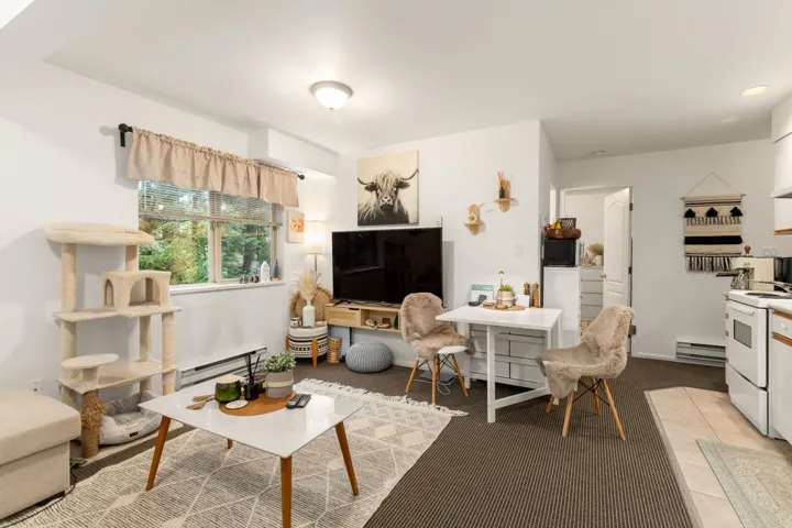 Suite Living room and Eat-In Kitchen with baseboard heating and light colored carpet