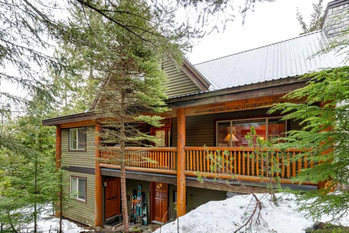 View of the exterior side with main floor deck area (28'3" x 5'0") and a covered entrance area / deck  below (14'4" x 4'5")