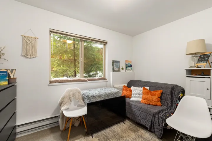 Second Suite Bedroom with baseboard heating and carpet flooring