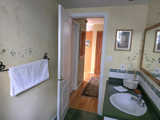 Half bathroom with vanity and baseboards