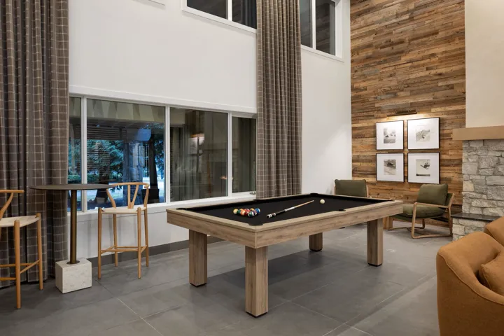 Recreation room featuring a towering ceiling and billiards table