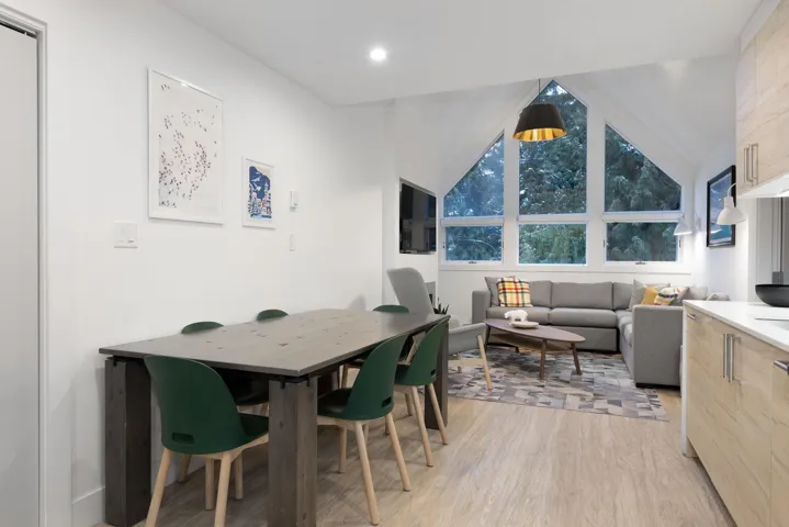 Dining area with lofted ceiling and light wood finished floors