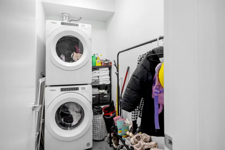 Laundry area featuring stacked washer and clothes dryer