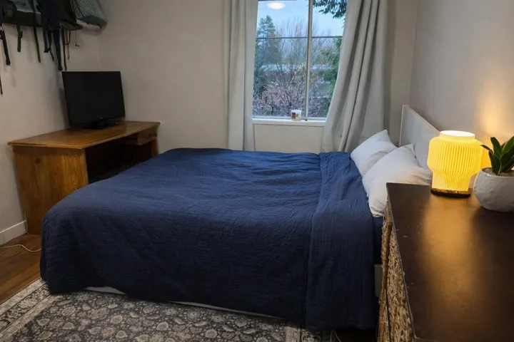 Bedroom featuring wood finished floors and baseboards