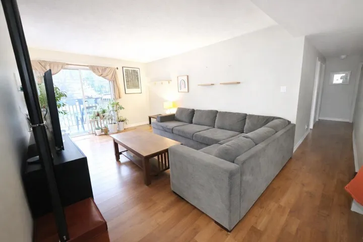 Living area with wood finished floors and baseboards