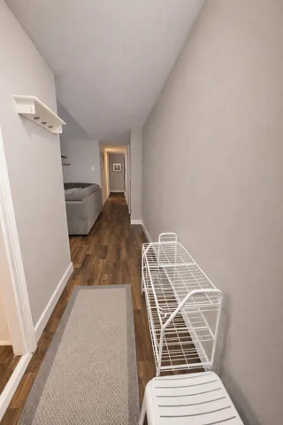 Hall featuring dark wood finished floors